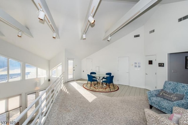 living area featuring carpet, rail lighting, high vaulted ceiling, and beamed ceiling