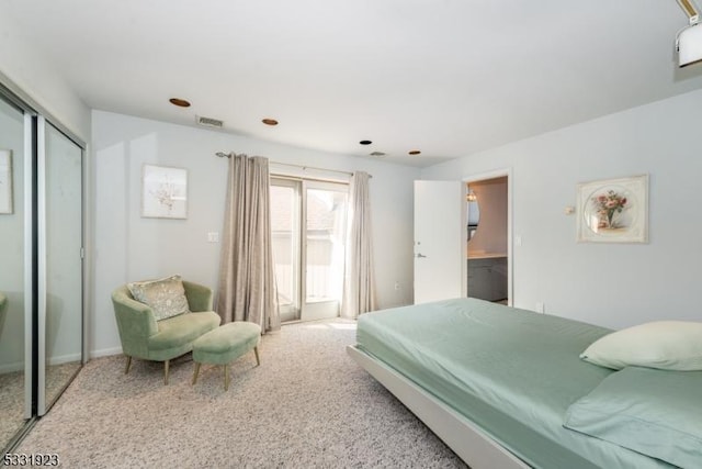 carpeted bedroom featuring connected bathroom