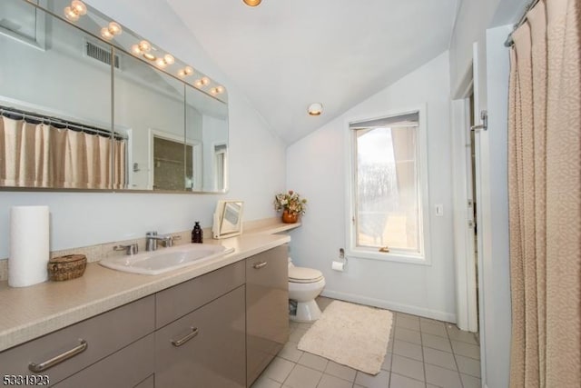 bathroom featuring vanity, vaulted ceiling, tile patterned flooring, toilet, and walk in shower