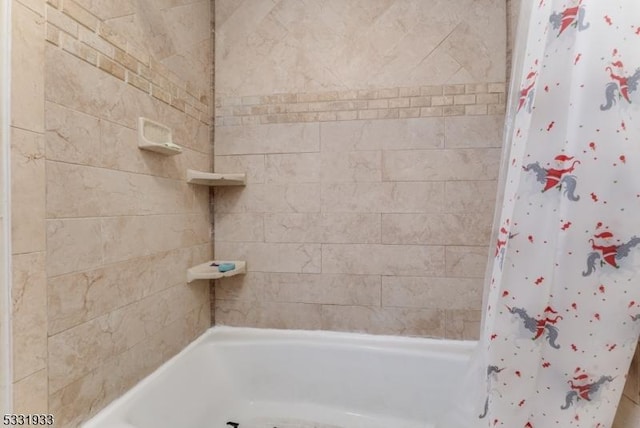 bathroom with shower / bath combination with curtain