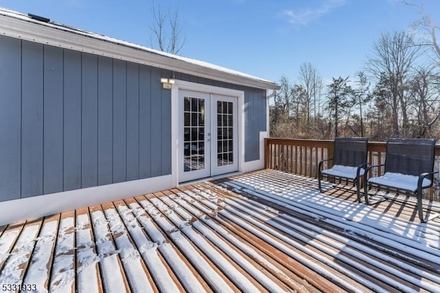 snow covered deck with french doors