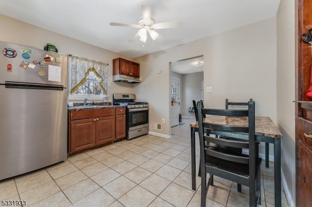 kitchen featuring ceiling fan, sink, light tile patterned floors, and stainless steel appliances