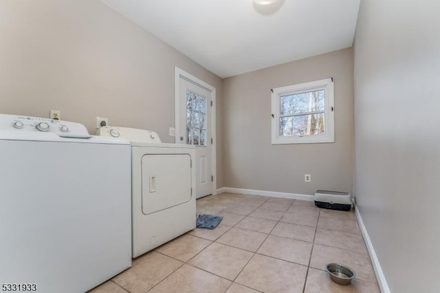 laundry room with separate washer and dryer and light tile patterned floors