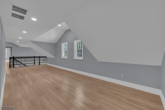 bonus room featuring light hardwood / wood-style floors and lofted ceiling