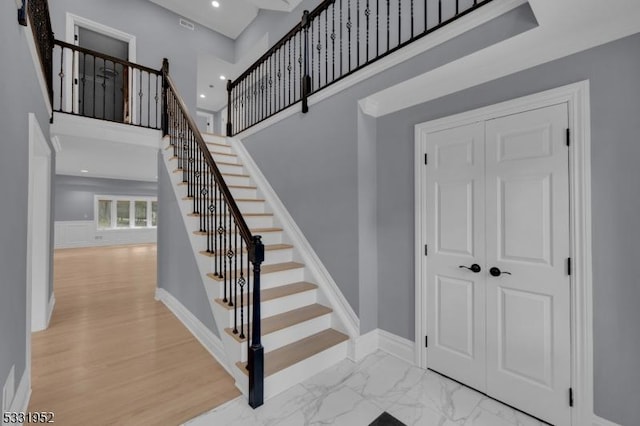 staircase featuring a high ceiling