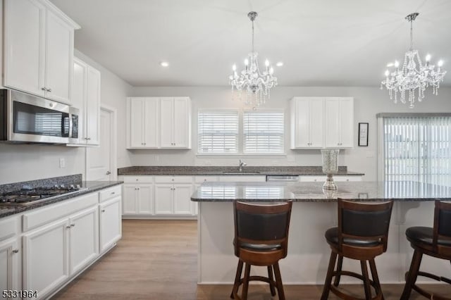 kitchen featuring a kitchen island, white cabinetry, and appliances with stainless steel finishes