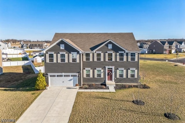 view of front of house featuring a front yard and a garage