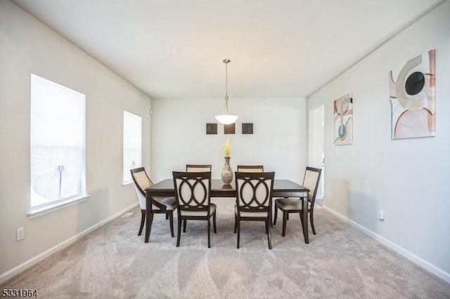 dining space with light colored carpet