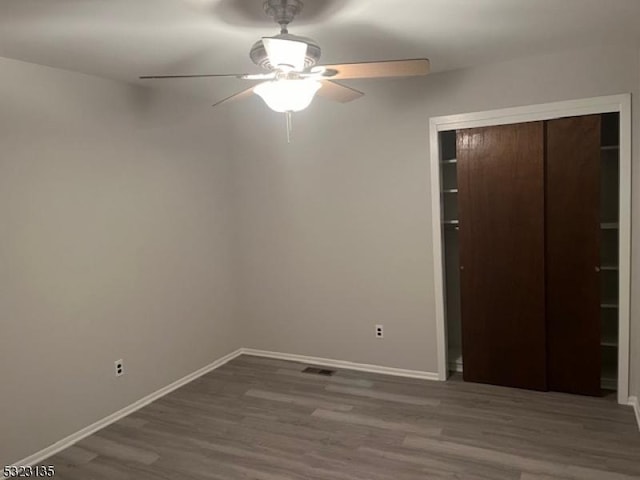 empty room featuring hardwood / wood-style floors and ceiling fan