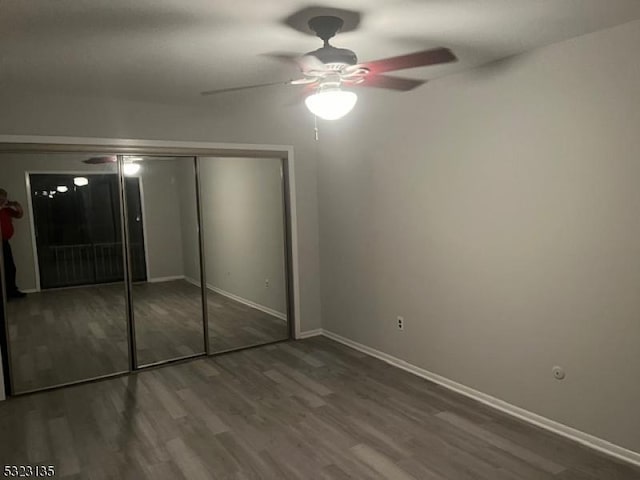 unfurnished bedroom with hardwood / wood-style floors, a closet, and ceiling fan