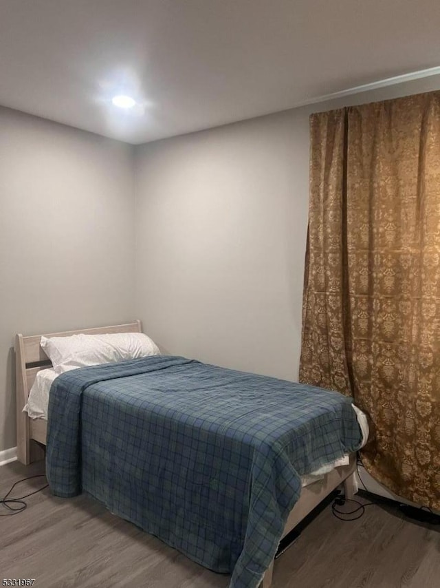 bedroom with wood-type flooring