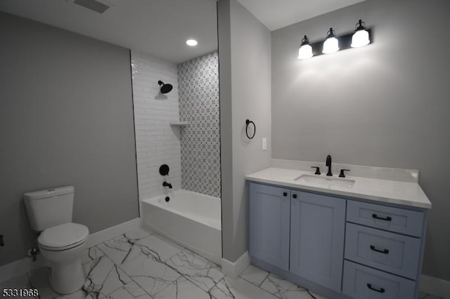 full bathroom featuring vanity, tiled shower / bath combo, and toilet