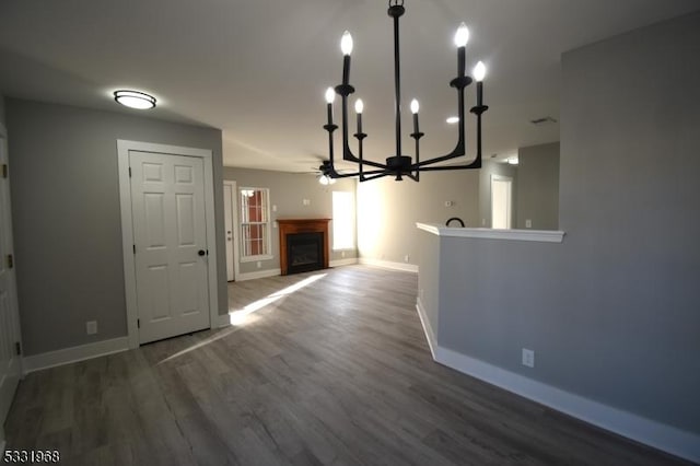 unfurnished dining area featuring dark hardwood / wood-style flooring and a notable chandelier