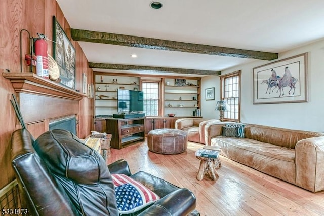 living room featuring wood-type flooring and beam ceiling