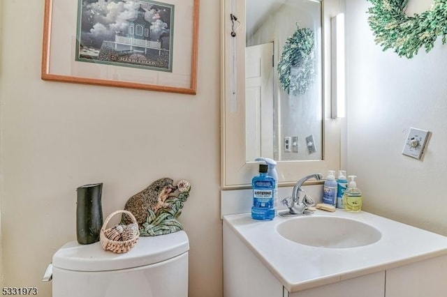 bathroom with toilet and vanity