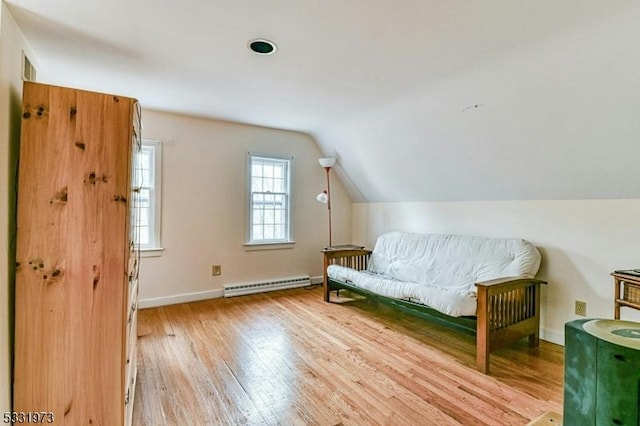 bonus room featuring baseboard heating, light hardwood / wood-style flooring, and vaulted ceiling