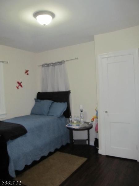 bedroom featuring dark hardwood / wood-style flooring