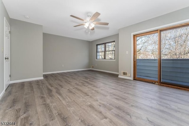 unfurnished room with light wood-type flooring and ceiling fan