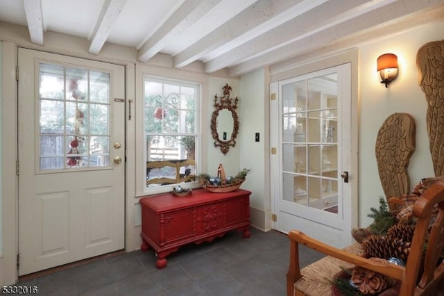 doorway to outside featuring beamed ceiling