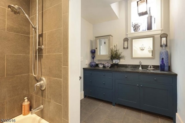 bathroom with vanity, tile patterned floors, and tiled shower / bath