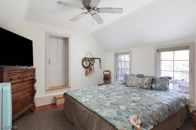 bedroom with dark hardwood / wood-style floors, ceiling fan, and lofted ceiling