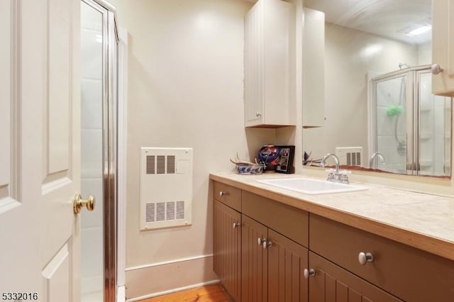 bathroom featuring vanity and heating unit