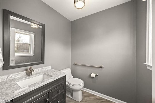 bathroom featuring hardwood / wood-style flooring, vanity, and toilet