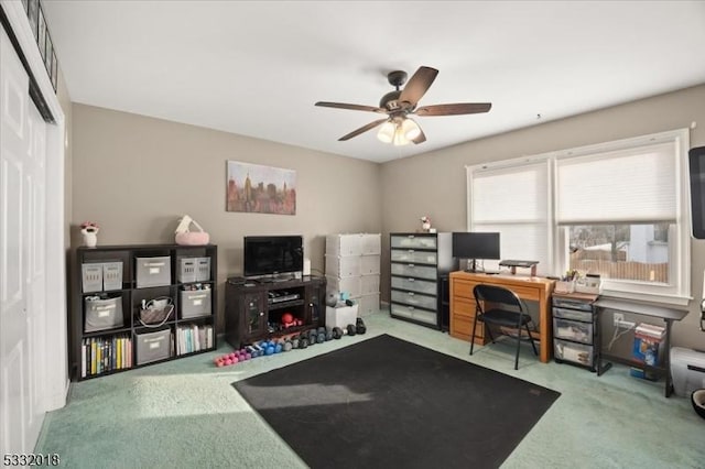 carpeted home office with ceiling fan