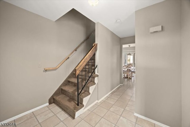 stairs featuring tile patterned flooring