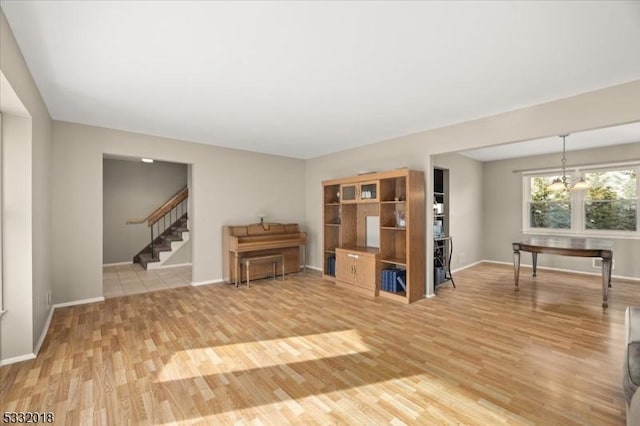 unfurnished living room with a chandelier and hardwood / wood-style flooring