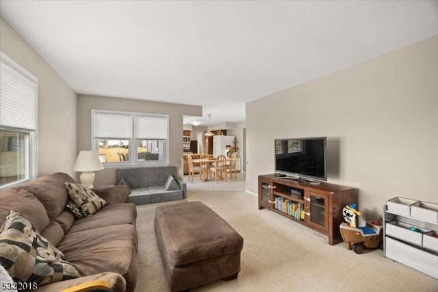 living room featuring carpet floors and a wealth of natural light