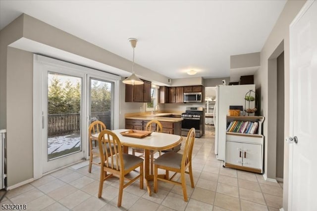 dining area with sink and light tile patterned floors