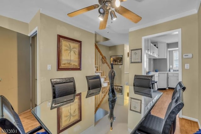 home office with ceiling fan, light hardwood / wood-style floors, and crown molding