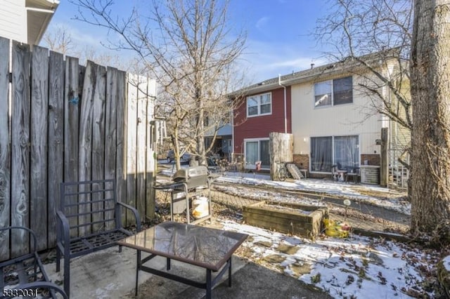 snow covered property featuring a patio area