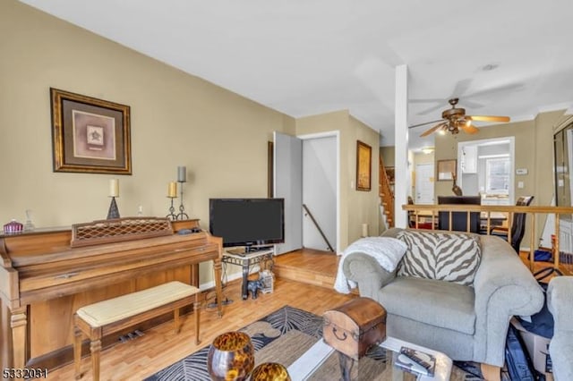 living room featuring ceiling fan and wood-type flooring