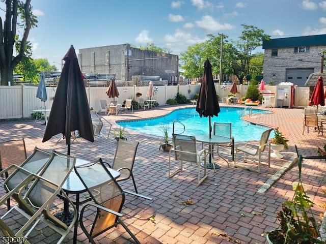 view of swimming pool featuring a patio area