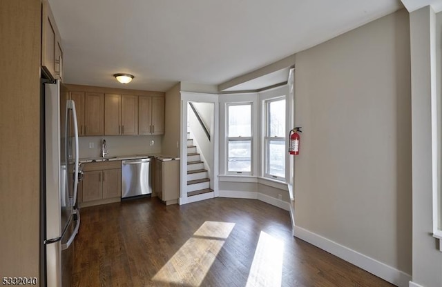 kitchen featuring appliances with stainless steel finishes and dark hardwood / wood-style floors