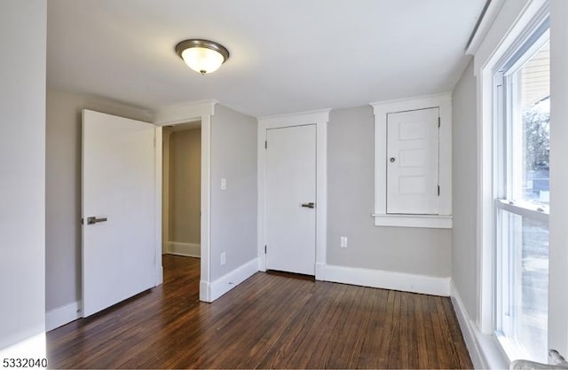 empty room with dark hardwood / wood-style floors