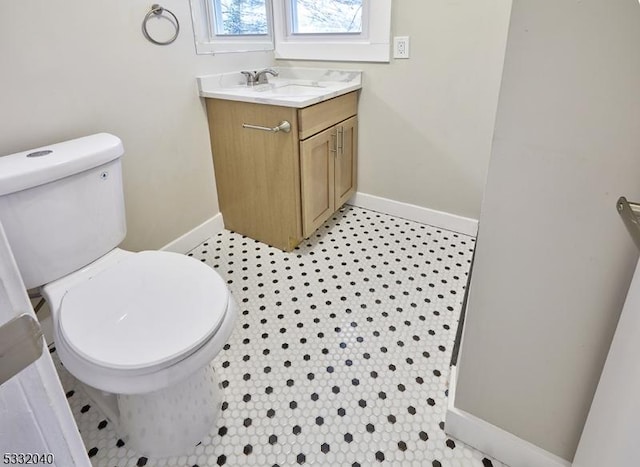 bathroom with tile patterned floors, vanity, and toilet