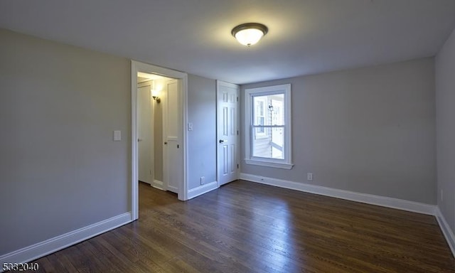 spare room with dark hardwood / wood-style floors