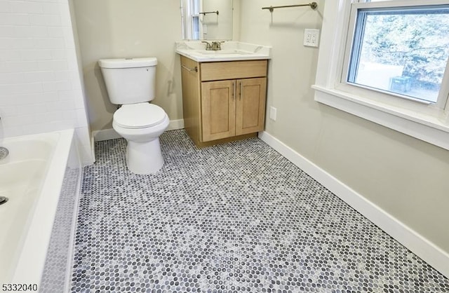 bathroom with tile patterned flooring, vanity, and toilet