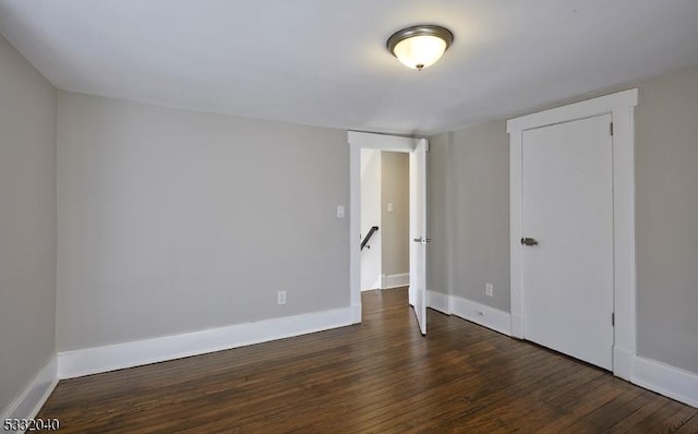 unfurnished bedroom with dark hardwood / wood-style floors