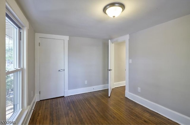 empty room with dark hardwood / wood-style floors