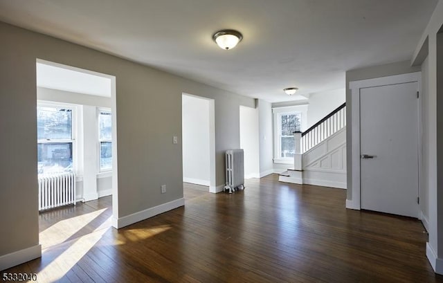 empty room with radiator and dark wood-type flooring