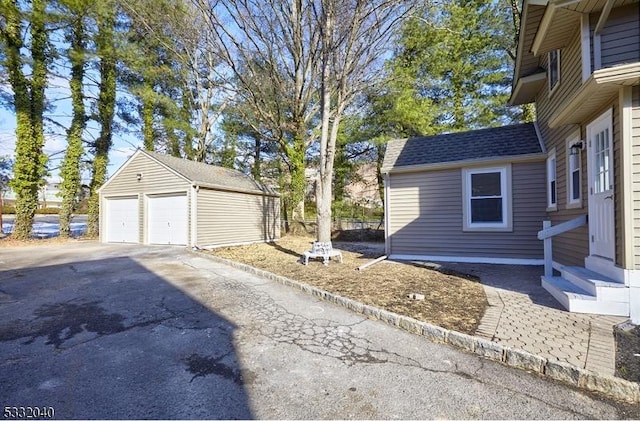 view of home's exterior featuring an outbuilding and a garage