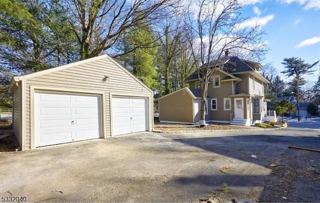 exterior space featuring an outbuilding and a garage