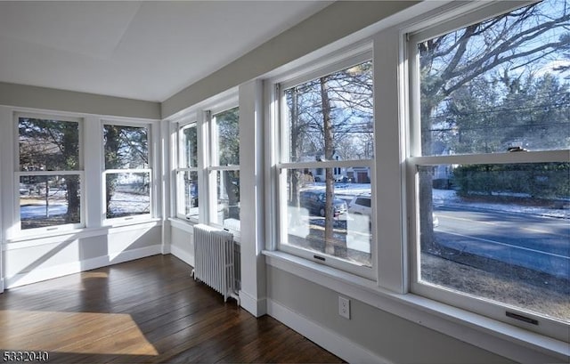 unfurnished sunroom with radiator heating unit and a healthy amount of sunlight