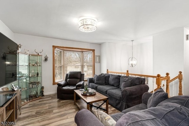 living room with hardwood / wood-style floors and a chandelier