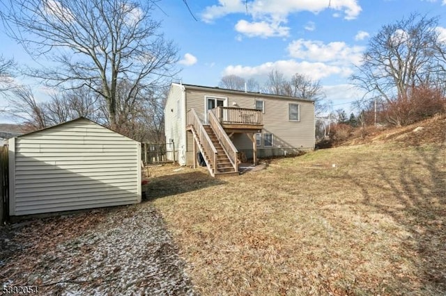 back of property with a yard, a shed, and a wooden deck