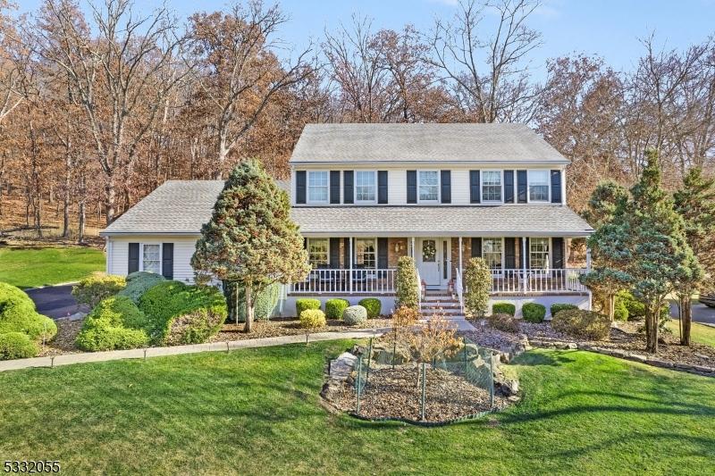 colonial house with a porch and a front yard